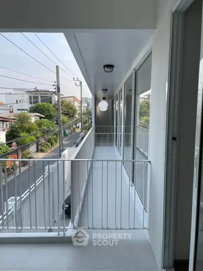 Spacious balcony with city view in modern apartment building