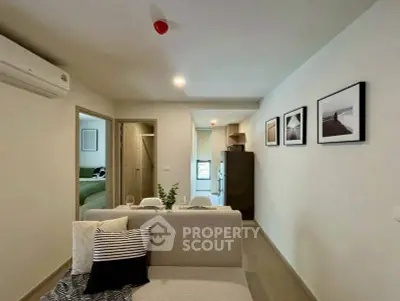 Modern living room with stylish decor and open layout, featuring a cozy sofa and contemporary wall art.