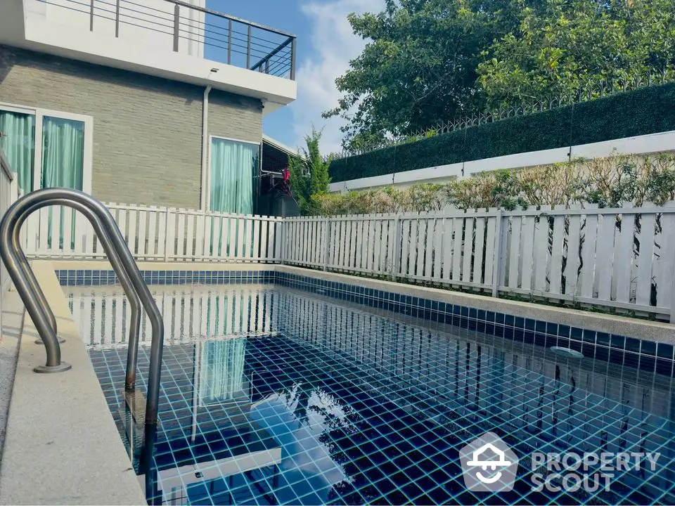 Luxurious modern home with private swimming pool and stylish exterior design.