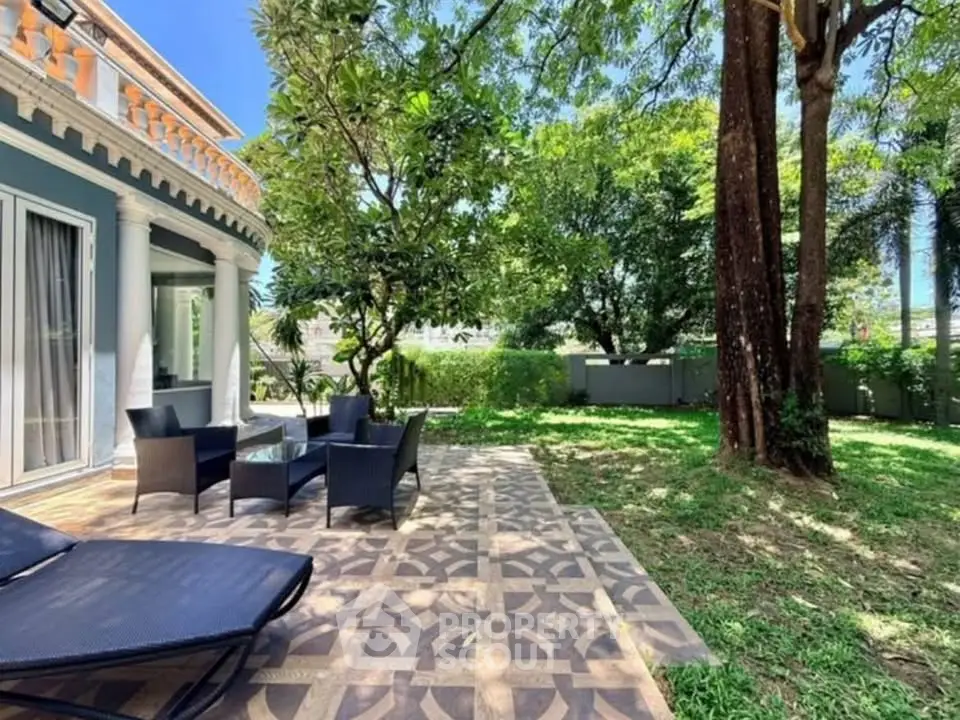 Charming garden view with elegant patio furniture and lush greenery