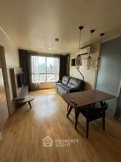 Modern living room with city view, stylish furniture, and natural light.