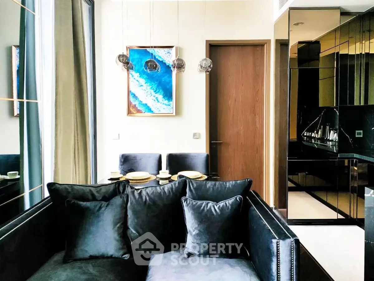 Luxurious modern living room with elegant black sofa and stylish dining area