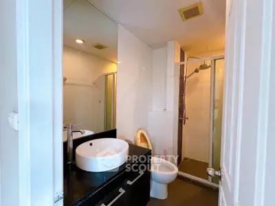 Modern bathroom with sleek fixtures and glass shower enclosure