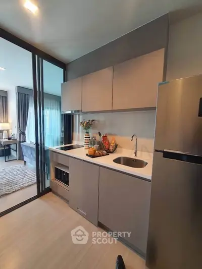 Modern kitchen with sleek cabinetry and stainless steel appliances in open layout.