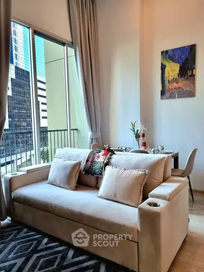 Modern living room with cozy sofa and dining area in a high-rise apartment with city view.