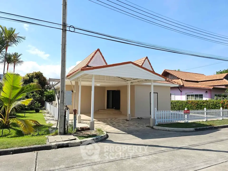 Charming suburban house with carport and lush garden in a peaceful neighborhood.