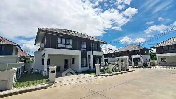 Modern two-story house with spacious driveway and clear blue sky.