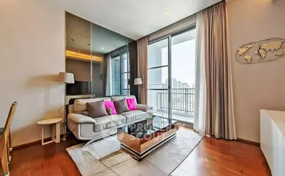 Modern living room with stylish decor and city view balcony in luxury apartment.