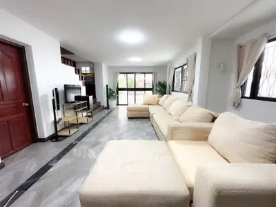Spacious living room with modern decor and large windows for natural light.