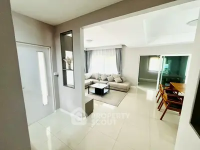 Modern living room with elegant decor and spacious layout, featuring a cozy seating area and dining space.