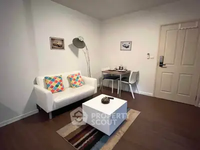 Cozy living room with modern decor and compact dining area, perfect for urban living.