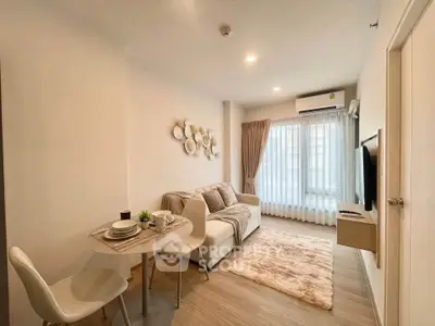 Modern living room with cozy decor and natural light in a stylish apartment.