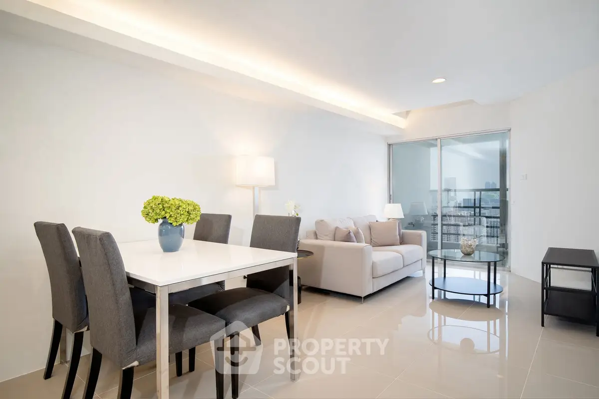 Modern living room with dining area and city view balcony in luxury apartment.