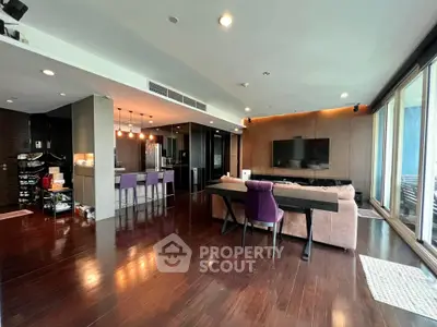 Spacious open-plan living area with modern kitchen, large windows, and sleek hardwood flooring, perfect for entertaining and relaxation.