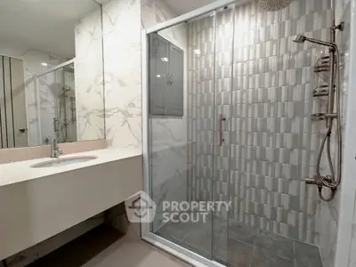 Modern bathroom with elegant shower and marble accents