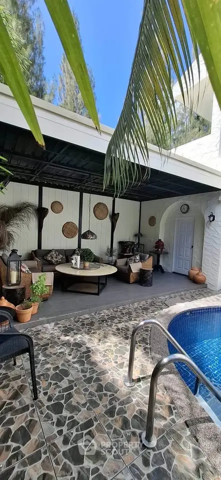 Luxurious outdoor pool area with stylish seating and lush greenery, perfect for relaxation and entertaining.