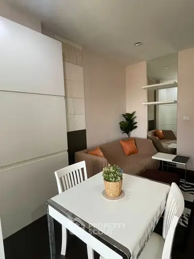 Cozy living room with modern decor and dining area, perfect for urban living.