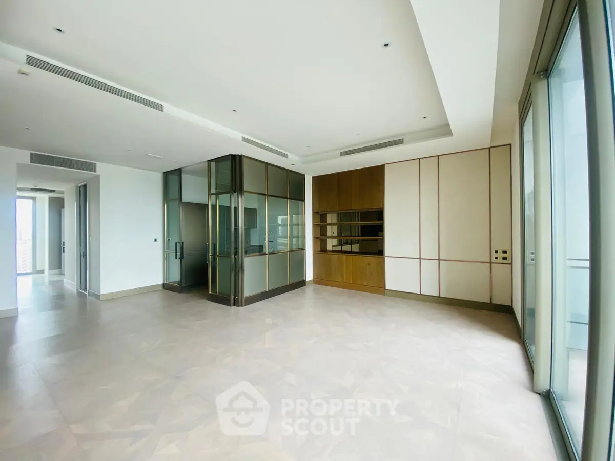 Spacious modern living room with floor-to-ceiling windows and elegant design.