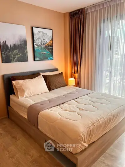 Cozy bedroom with modern decor and large window for natural light
