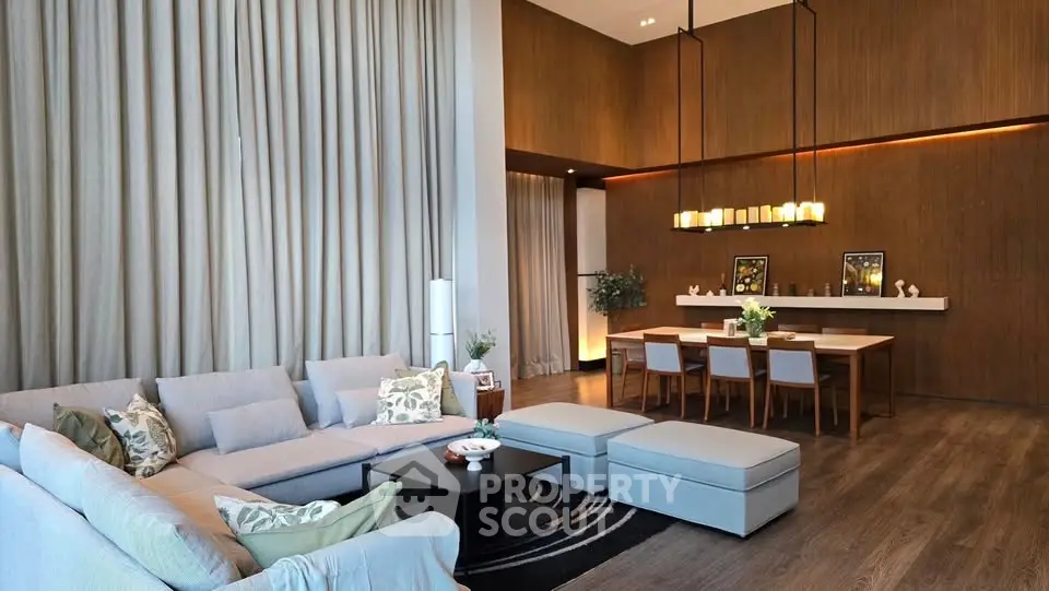 Luxurious modern living room with high ceilings and elegant dining area, perfect for entertaining.