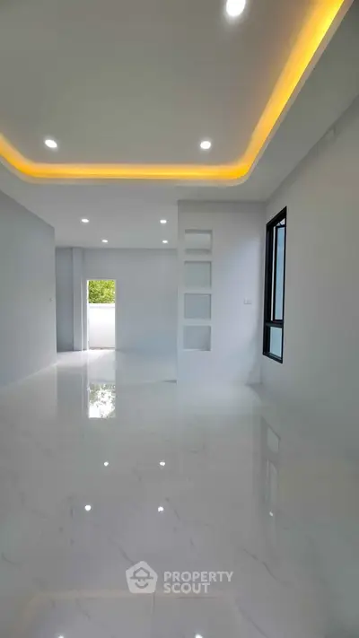 Spacious modern living room with elegant lighting and glossy floors