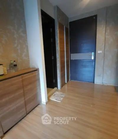 Stylish apartment entrance with wooden flooring and modern decor