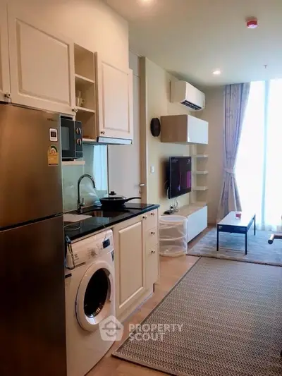 Modern compact living room with integrated kitchen and appliances