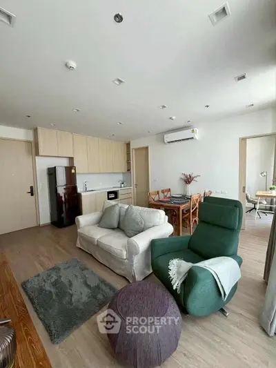 Modern living room with cozy seating and open kitchen layout