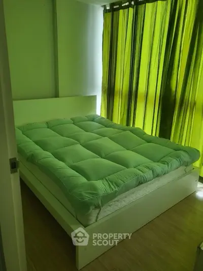 Cozy bedroom with green decor and natural light