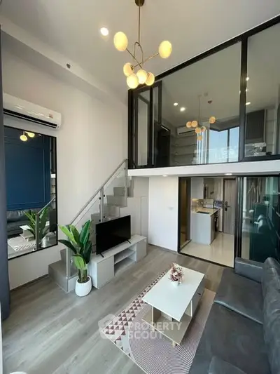 Modern duplex living room with stylish decor and open kitchen layout