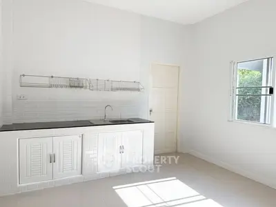 Bright minimalist kitchen with white brick walls and sleek cabinetry