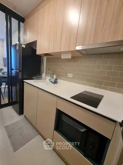 Modern kitchen with sleek cabinetry and built-in appliances in a stylish apartment.