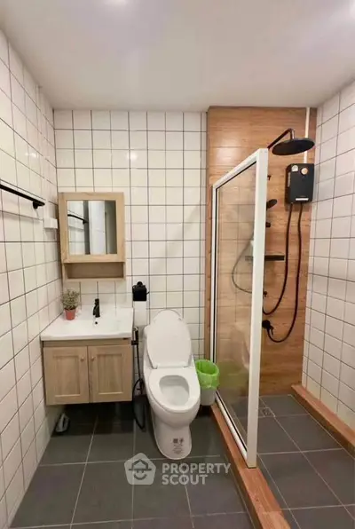 Modern bathroom with sleek shower and stylish vanity in a contemporary home.