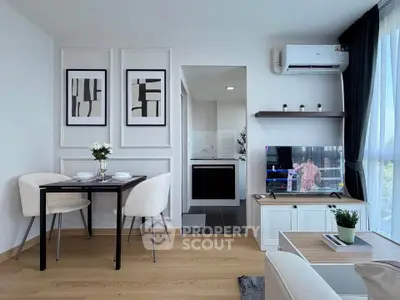 Modern living room with dining area and TV, featuring stylish decor and natural light.