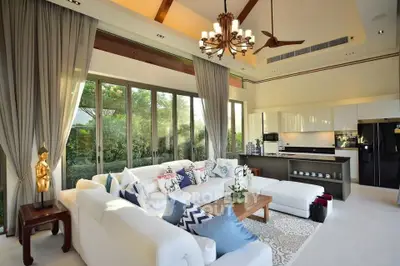 Luxurious open-layout living room with modern kitchen and garden view