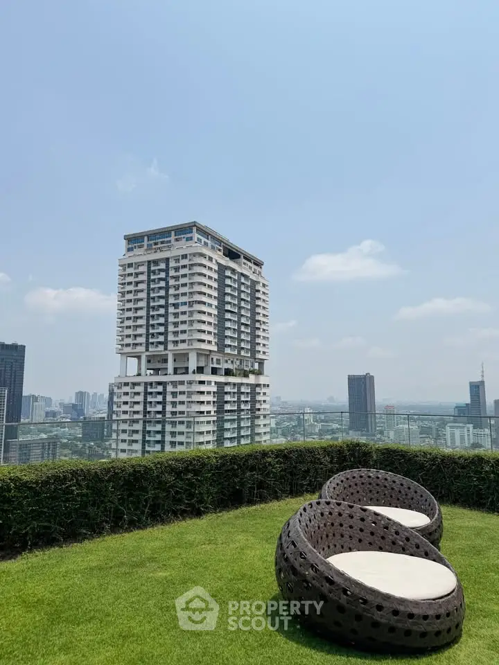 Stunning rooftop garden with panoramic city views and modern seating area.