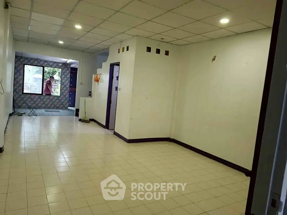 Spacious interior with tiled flooring and natural light, ideal for versatile living arrangements.