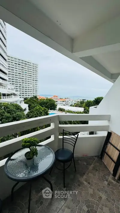 Charming balcony with ocean view in a modern high-rise building, perfect for relaxation and enjoying the scenery.