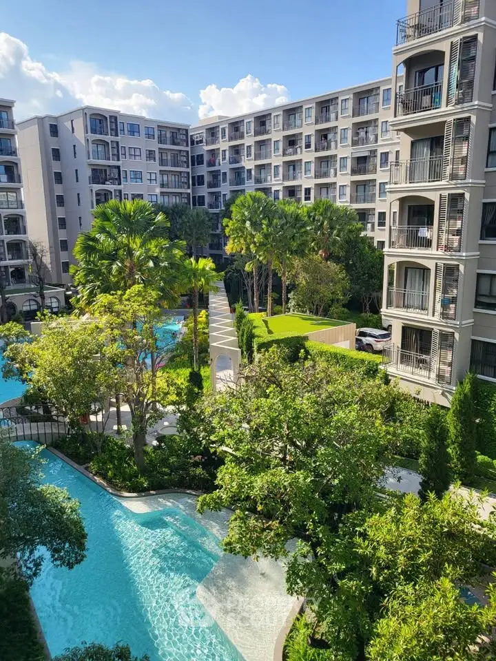 Luxurious apartment complex with lush gardens and inviting pool area