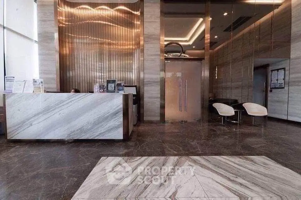Luxurious modern building entrance with marble floors and elegant reception area.