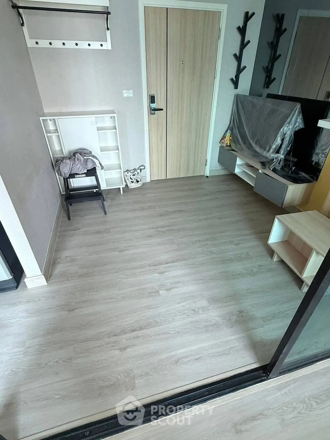 Modern entryway with sleek wooden flooring and stylish storage solutions.