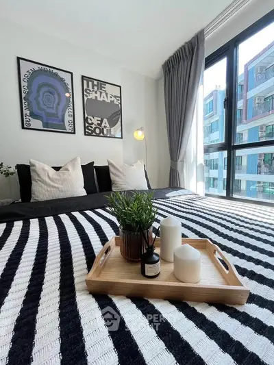 Modern bedroom with large window and stylish decor in urban apartment
