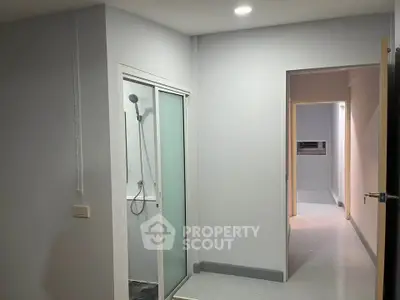 Modern apartment interior with shower and hallway, ideal for urban living.