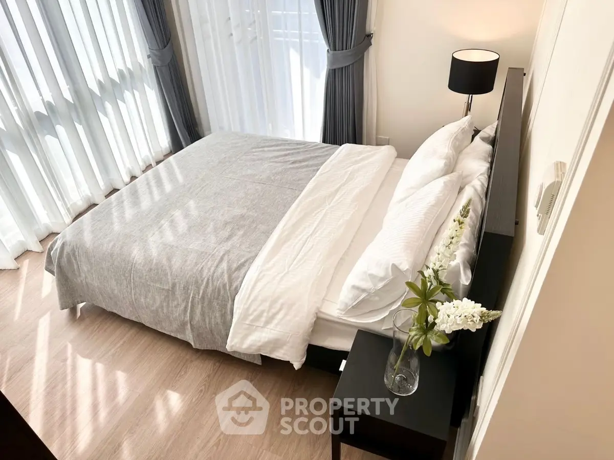 Bright and cozy bedroom with modern decor and large windows