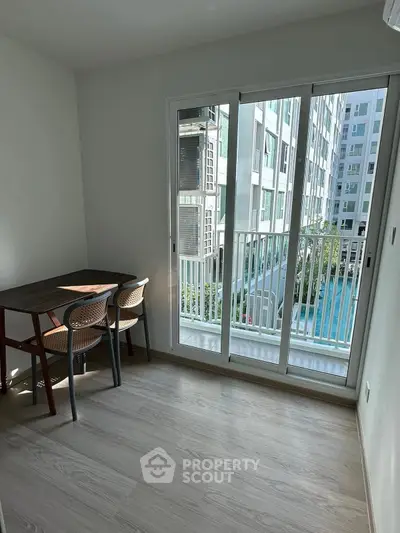 Bright study room with pool view and modern furniture in a high-rise apartment