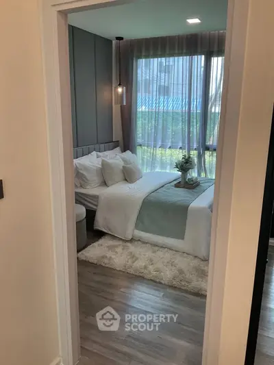 Cozy modern bedroom with large window and stylish decor