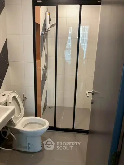 Modern bathroom with sleek shower enclosure and contemporary fixtures.