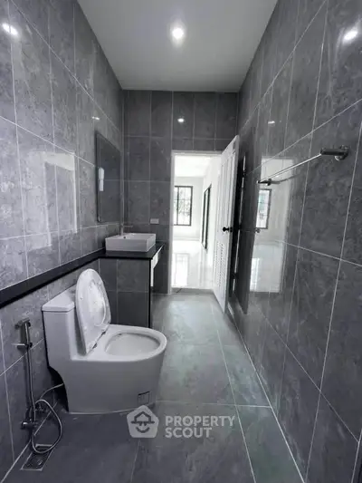 Modern bathroom with sleek gray tiles and contemporary fixtures
