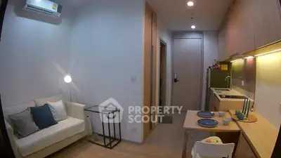 Modern compact living room with open kitchen in stylish apartment