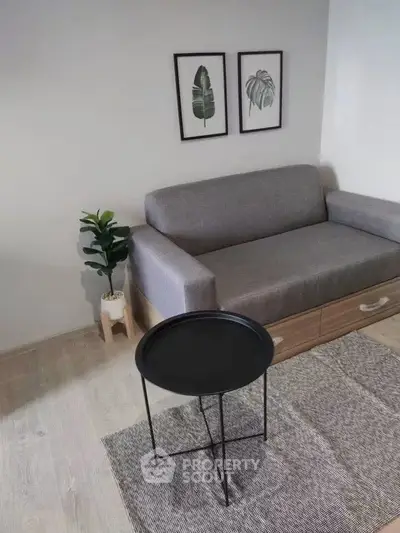 Modern living room with gray sofa, stylish decor, and minimalist design.